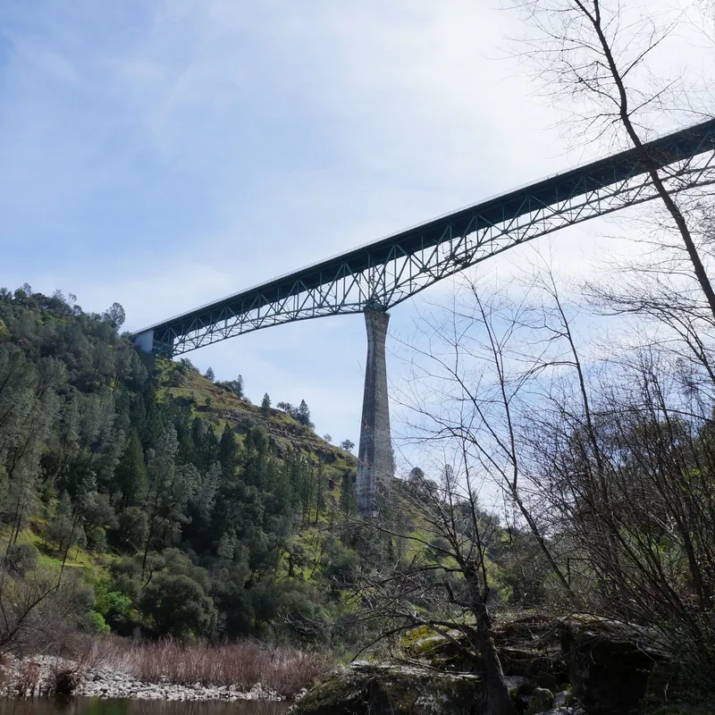 Historic stone bridge spanning across calm water